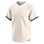 Beige honkbalshirt met korte mouwen en kleine gekleurde stipjes; mouwboorden donkerblauw met rood